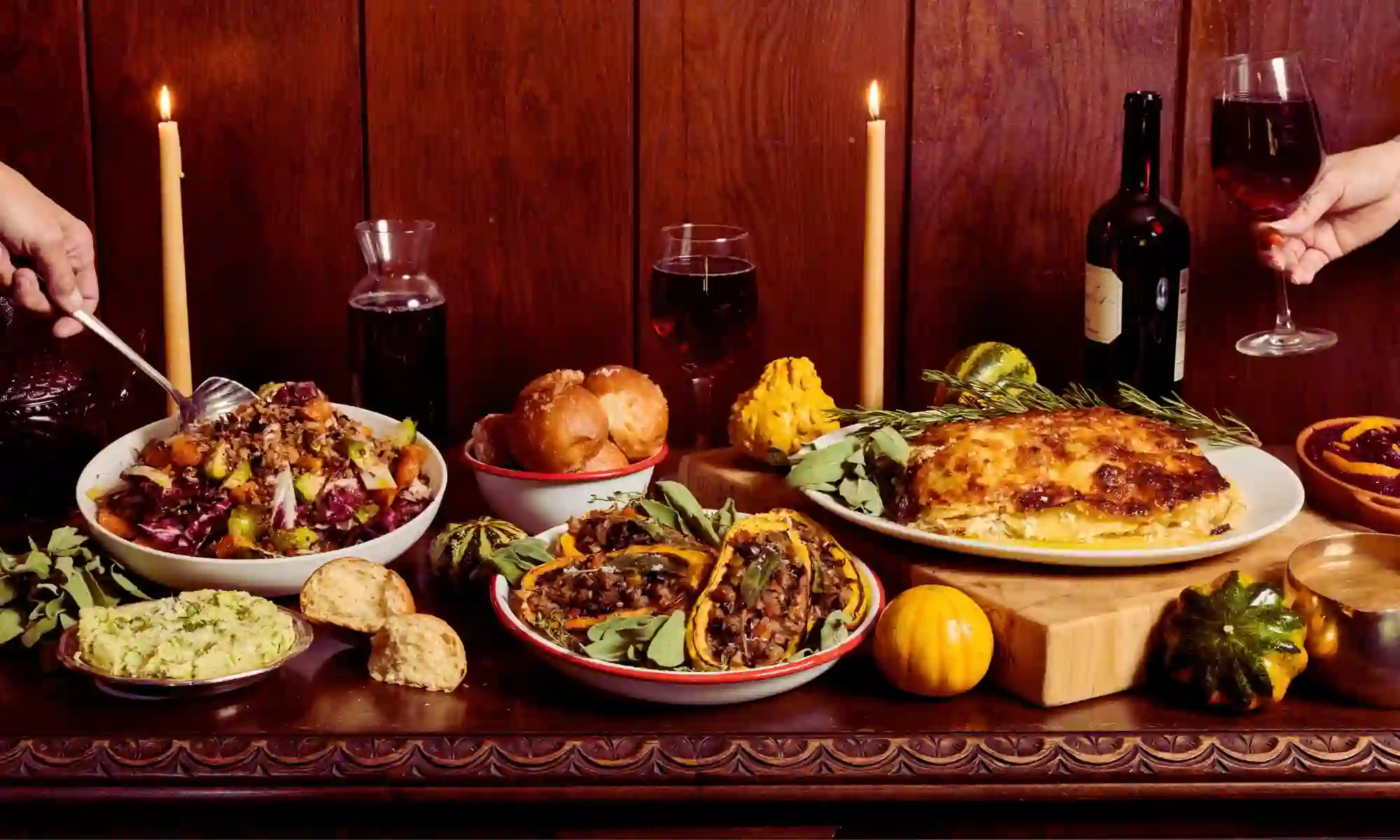 Thanksgiving catering table at Carnation Farms with roasted squash, salad, rolls, wine, candles, and holiday sides in Carnation, WA.